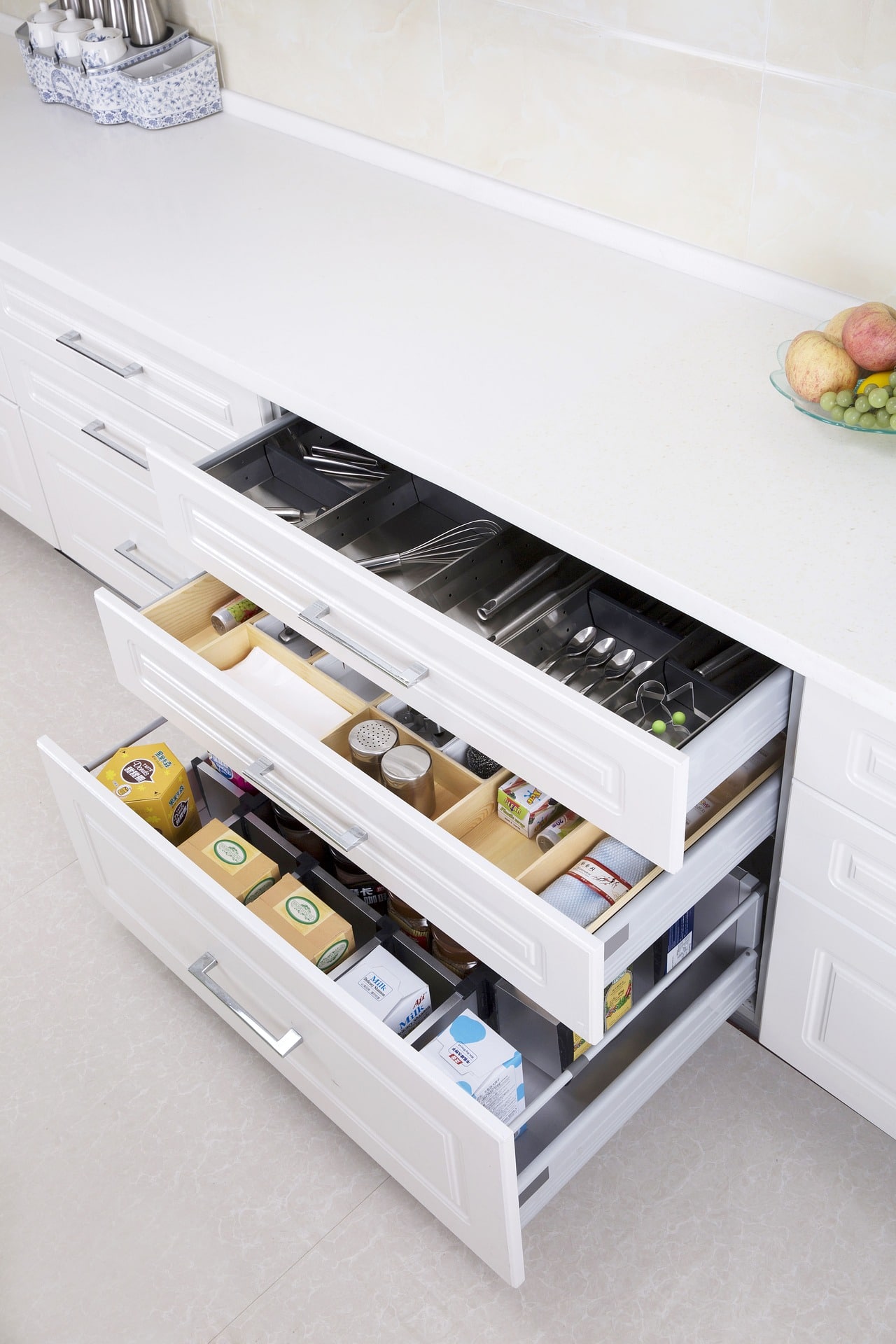 White Drawers filled with Kitchen Utensils.