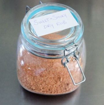 Glass jar filled with red and orange spices.