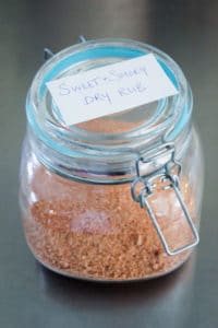 Glass jar filled with red and orange spices.