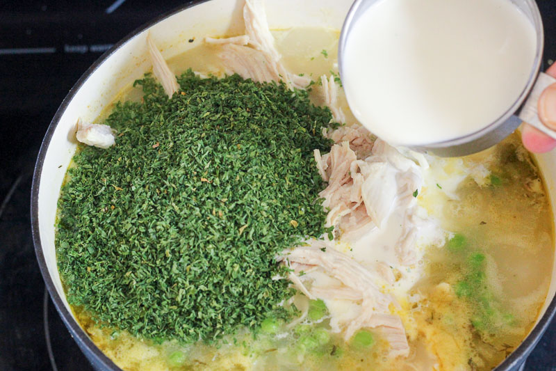 Adding Cream and Chopped Parsley to Pot of Soup.