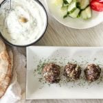 This Easy Greek Meatballs recipe packs a TON of flavour into little tiny meatball packages! They're easy to make, bake quickly in the oven, and freeze super well. This recipe uses just a few pantry staples for a delicious, garlicky, meal, infused with delicious herbs. Who doesn't need an easy and delicious freezer meal at this (or any!) time of year?
