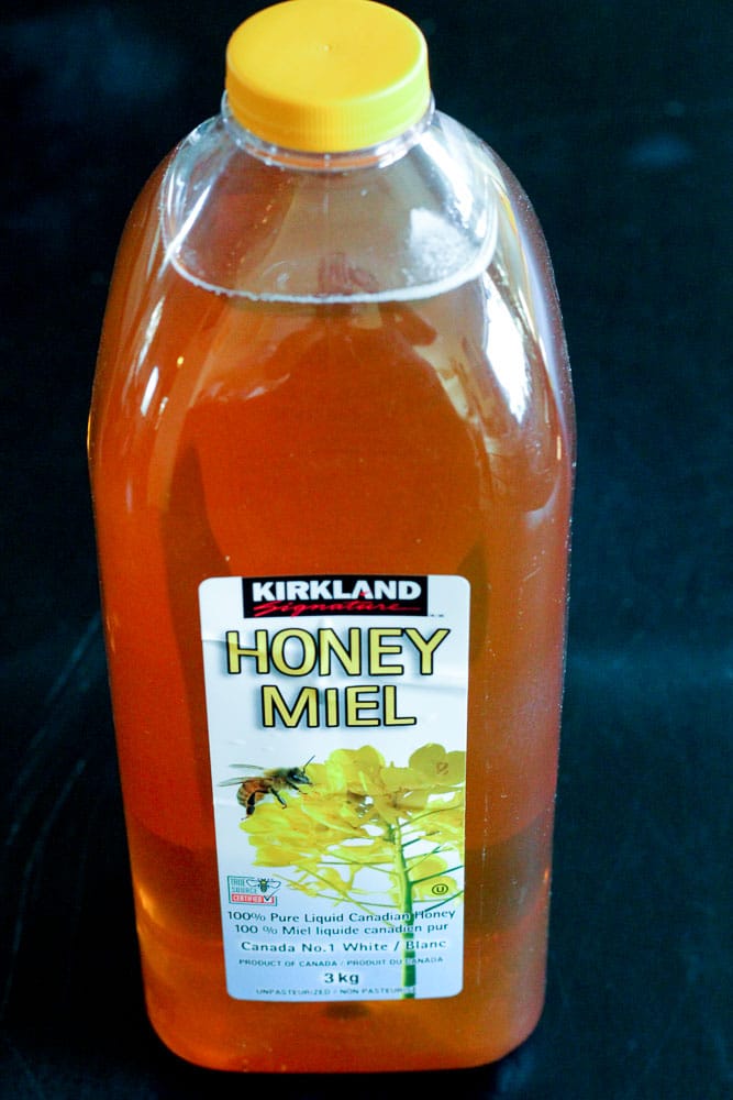 Bottle of Honey with Yellow Cover.