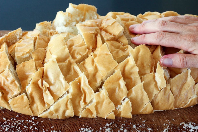 Hand on Top of Sliced Loaf of Bread.