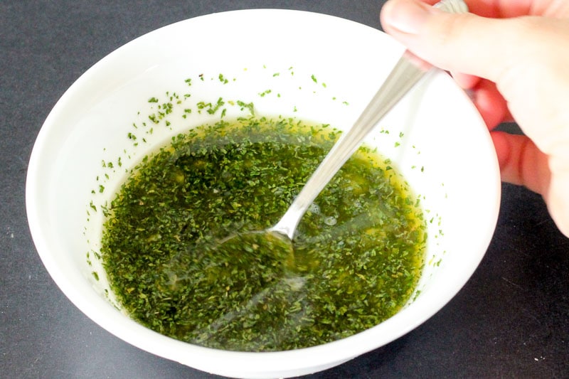 Melted Butter, Garlic and Parsley in White Bowl.