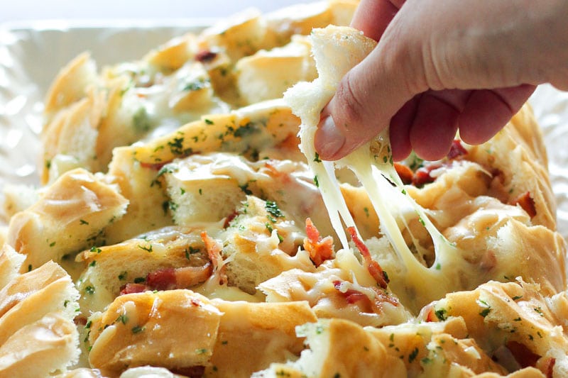 Cheesy pull apart bread topped with bacon and parsley.