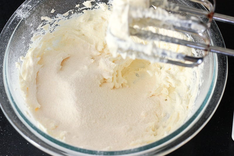 Adding Vanilla Pudding Powder to Cream cheese in Glass Bowl.