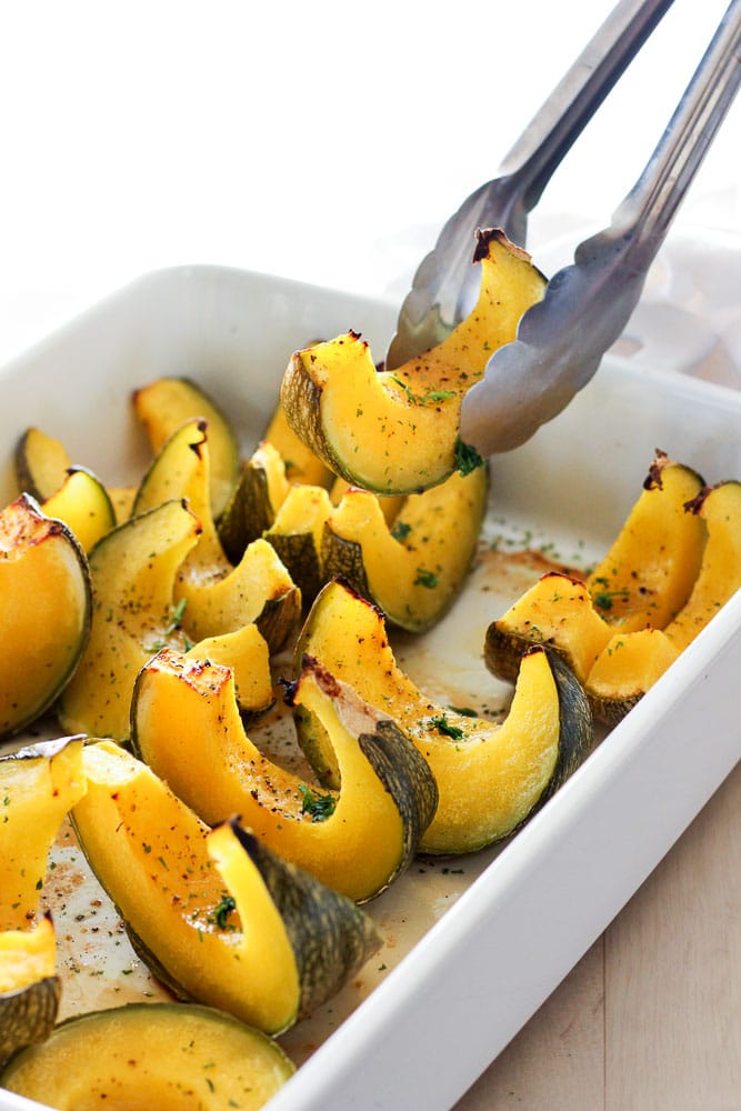 Sliced Oven Baked Maple Squash in White Dish.