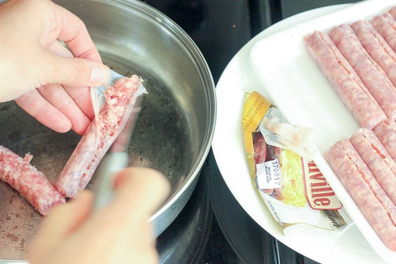 Removing sausage from casings and putting it in Frying Pan.