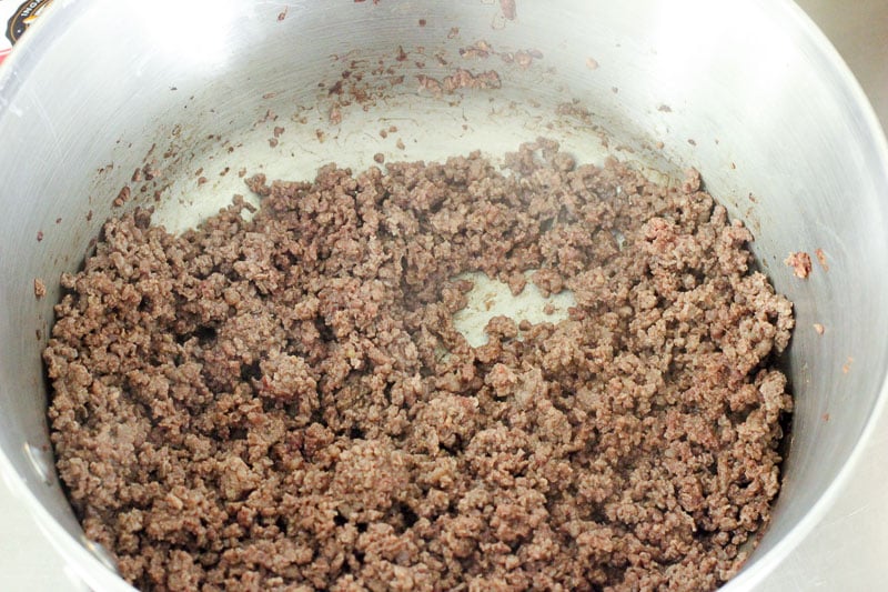 Crumbled Beef Browning in Metal Pot.