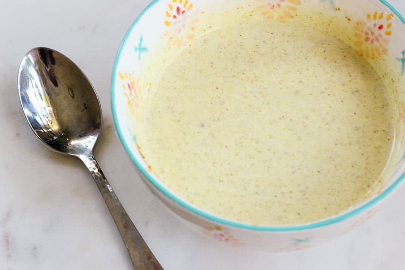 Creamy Maple Curry Salad Dressing in White Bowl.