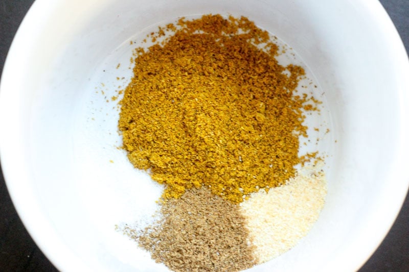 Curry Powder, Cumin, Garlic Powder and Salt in White Bowl.