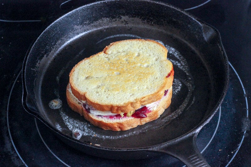Grilled Turkey, Cream Cheese and Cranberry Sandwich in Cast Iron Frying Pan.
