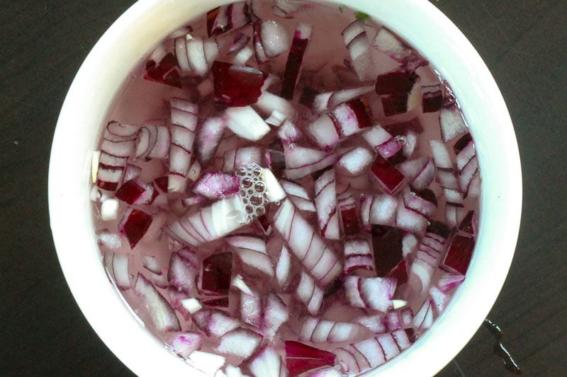 Soaking Chopped Red Onions in Water in a White Bowl.