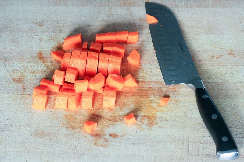 Chopping Carrots on Wooden Board.