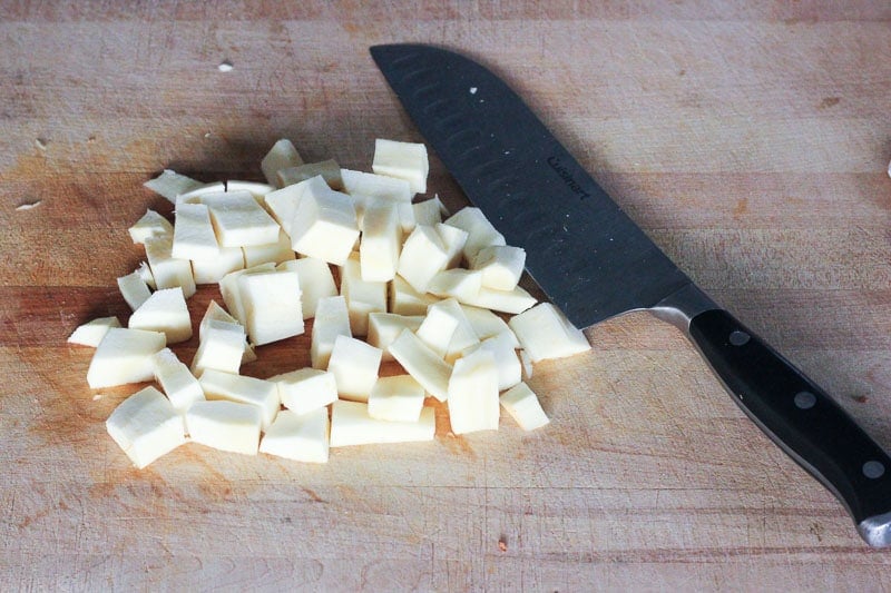 Chopping Parsnip on Wooden Board.