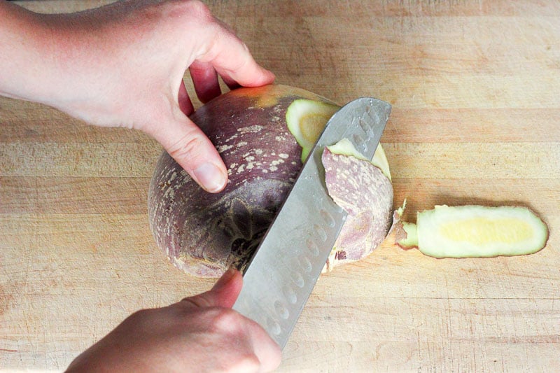 Peeling turnip on Wooden Board.