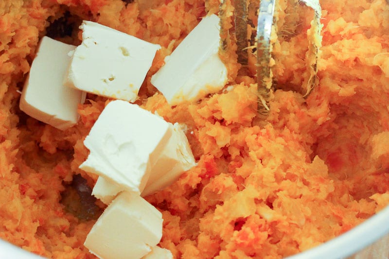Adding Butter and Cream Cheese to Root Vegetable Mash.