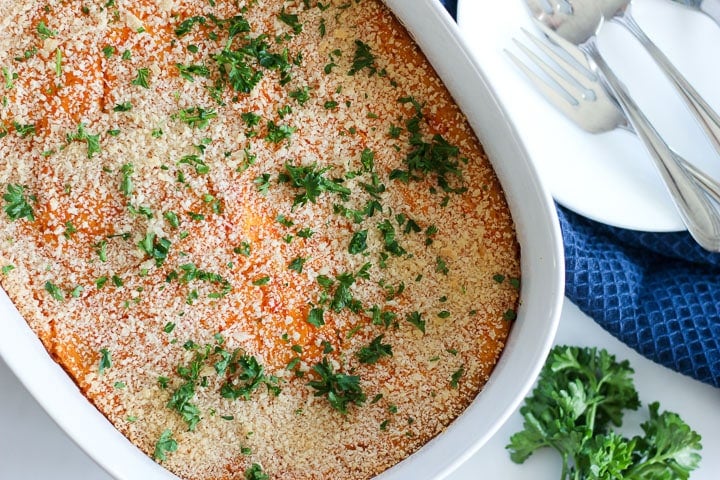 Serving dish of winter vegetable casserole with breadcrumbs