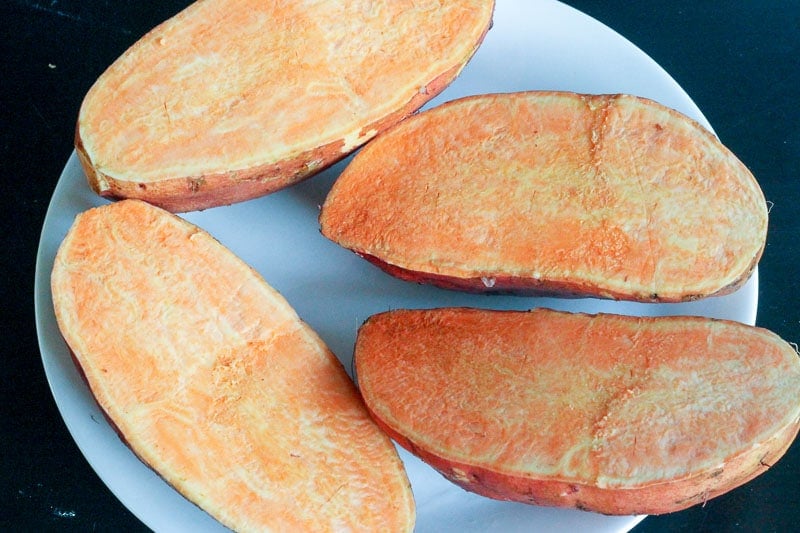 Sweet Potatoes Sliced in Half on White Plate.