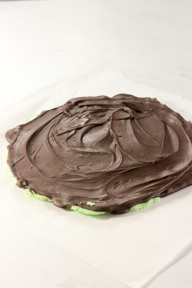Chocolate Spread on top of Green Chocolate Mixture on Parchment Paper.