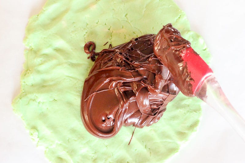 Spreading Melted Chocolate Chips onto Green Chocolate Mixture.