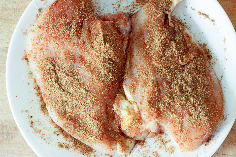 Spice mixture rubbed onto chicken in White Plate.