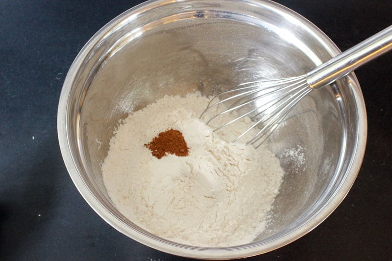 Flour, Baking Powder and Ground Nutmeg in Metal Mixing Bowl.
