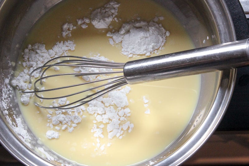 Mixing Eggnog and Cornstarch in Metal Mixing Bowl with Whisk.