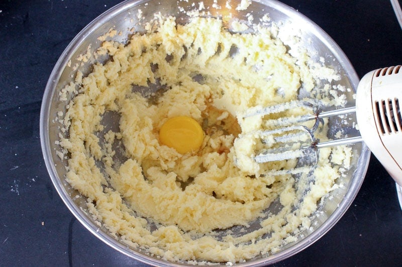 Sugar, Butter and Egg Mixture in Metal Mixing Bowl.