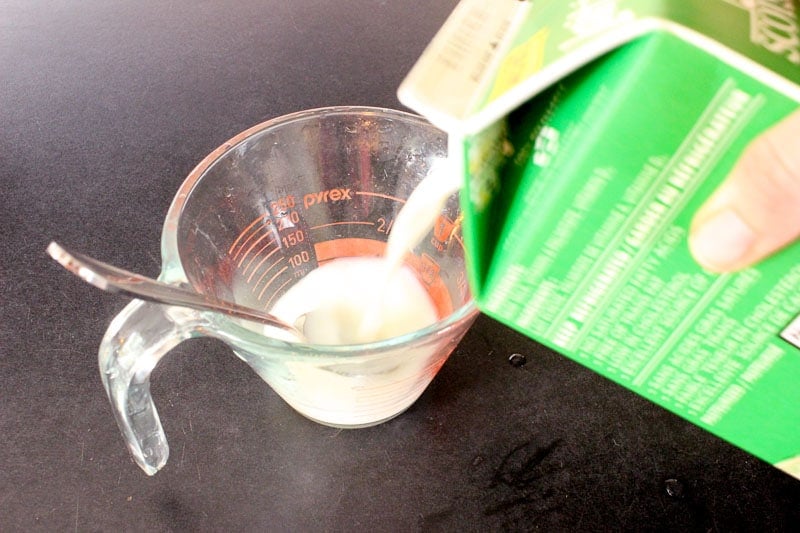 Adding Milk Into Glass Measuring Cup.