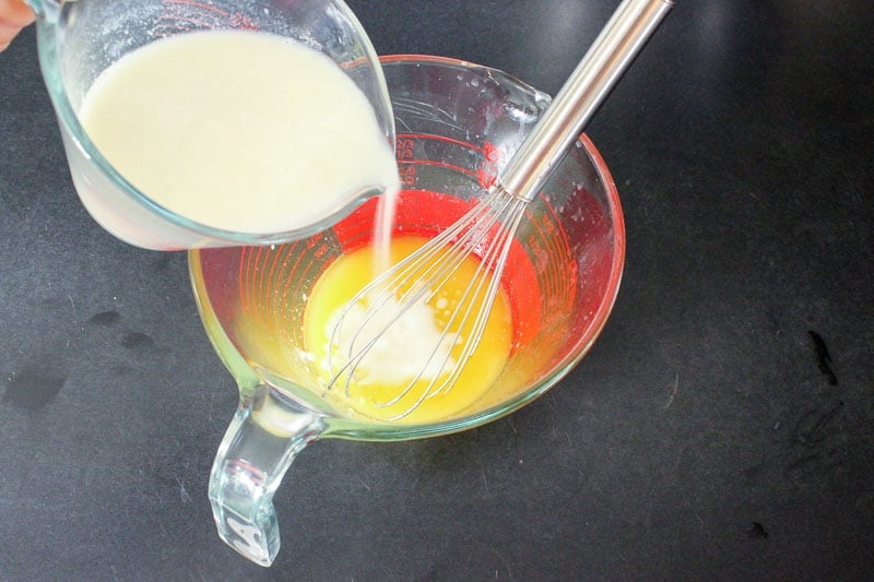 Adding Buttermilk to Melted Butter In Glass Measuring Cup.