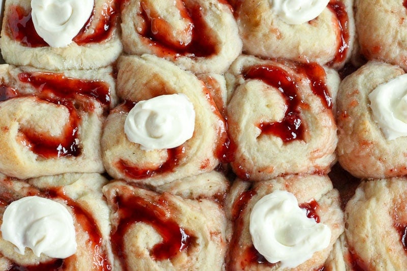 Strawberry Sweet Rolls topped with Vanilla Cream Cheese Icing.