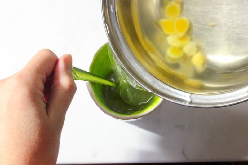 Pouring Ginger Water into Green Mug.