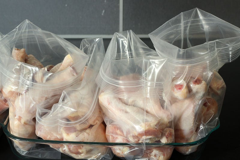 Raw Chicken Placed Inside Resealable Plastic Bags.