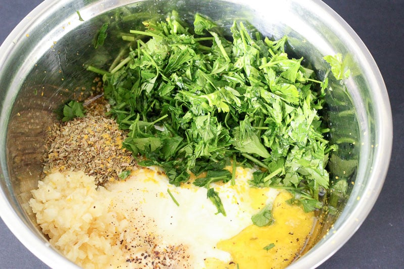 Spices and Chopped Herbs in Metal mixing Bowl.