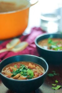 Maple Pork Chili Topped with Parsley in Black Bowls.