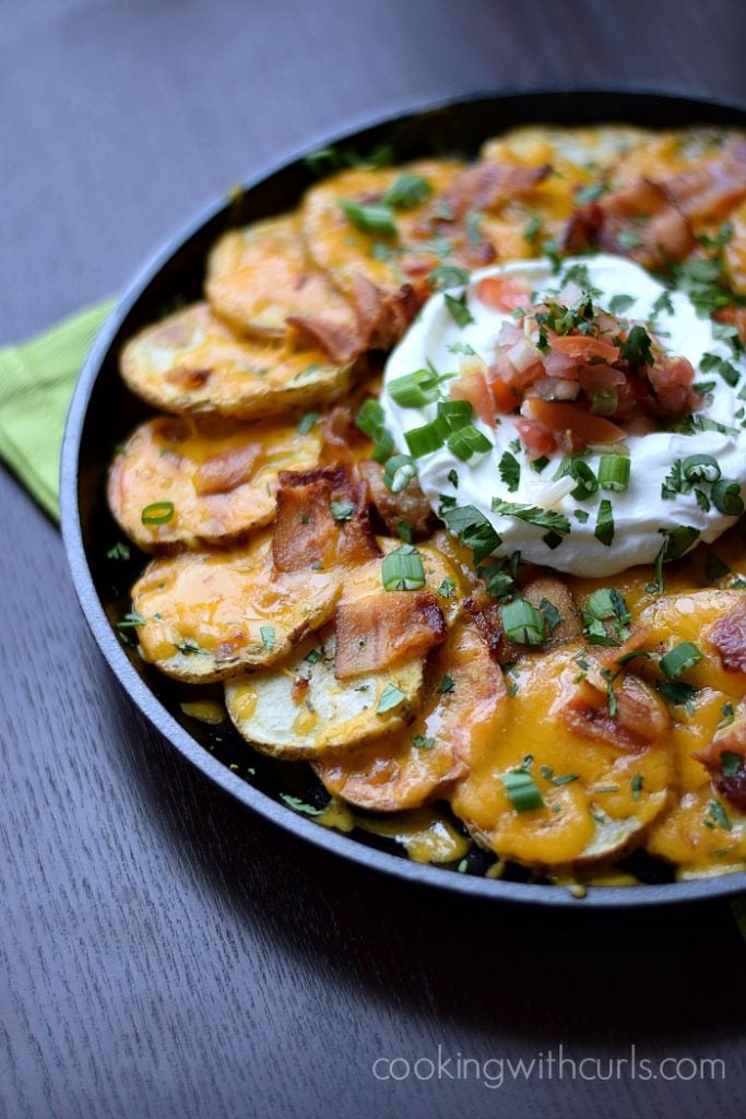Sliced Potatoes topped with bacon, Green Onions and Sour Cream.