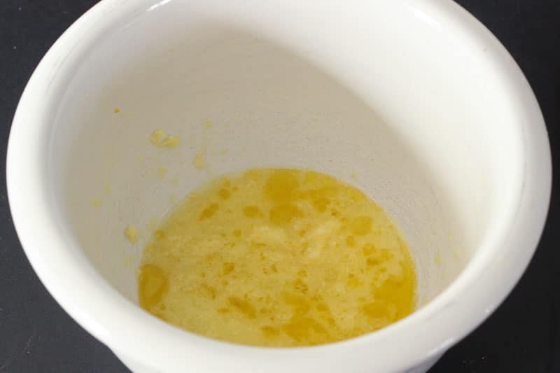 Mixing Lemon juice, ginger, salt and oil in White Bowl.