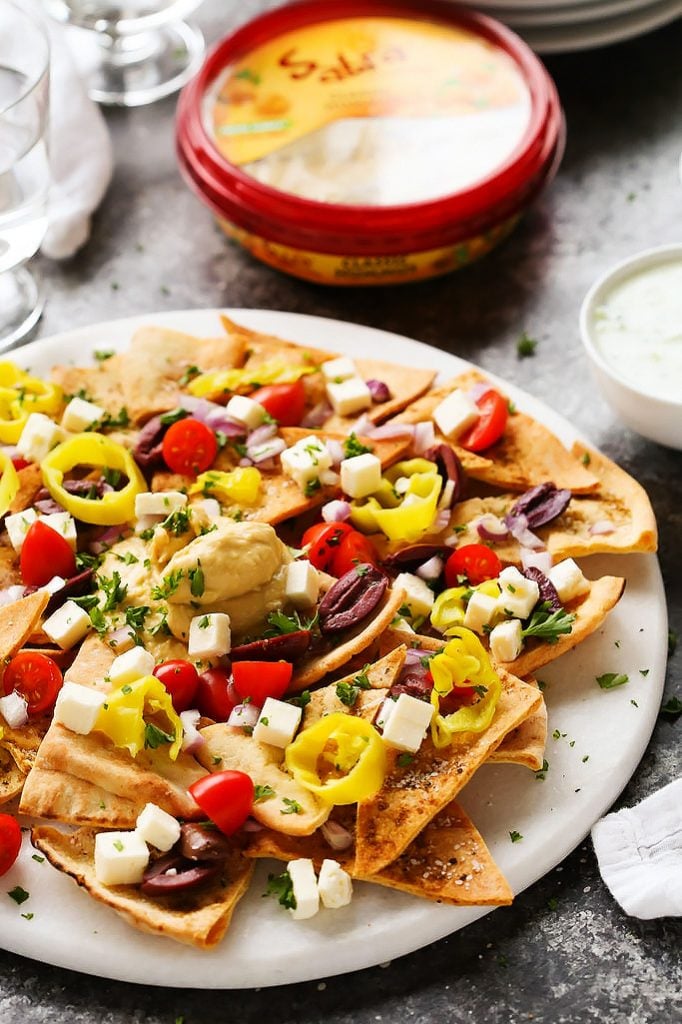Pita Chips Topped with Olives, Feta Cheese, Tomatoes and Parsley.