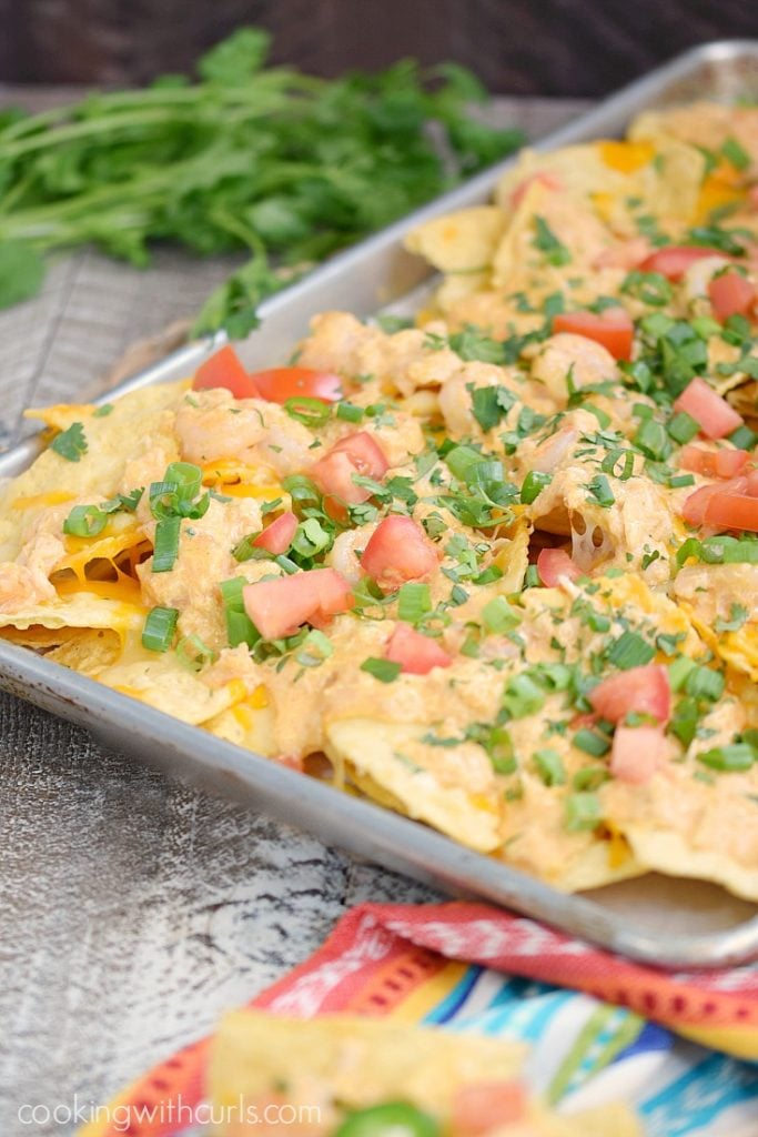 Nacho Chips topped with Shrimp, tomatoes and Green Onions.