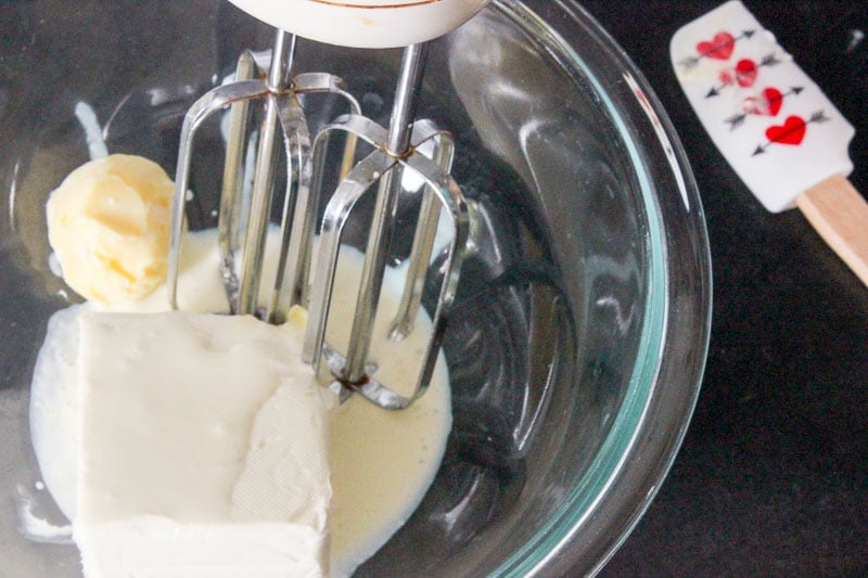 Mixing Cream Cheese, Butter and Milk in Glass Bowl.