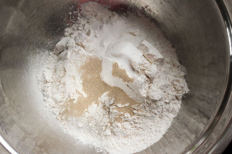 Mixing flour, yeast and salt together in Metal Bowl.