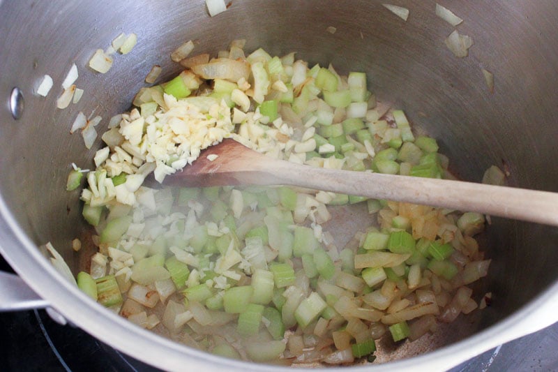 Onions, Celery and Garlic Frying in Metal Pot.