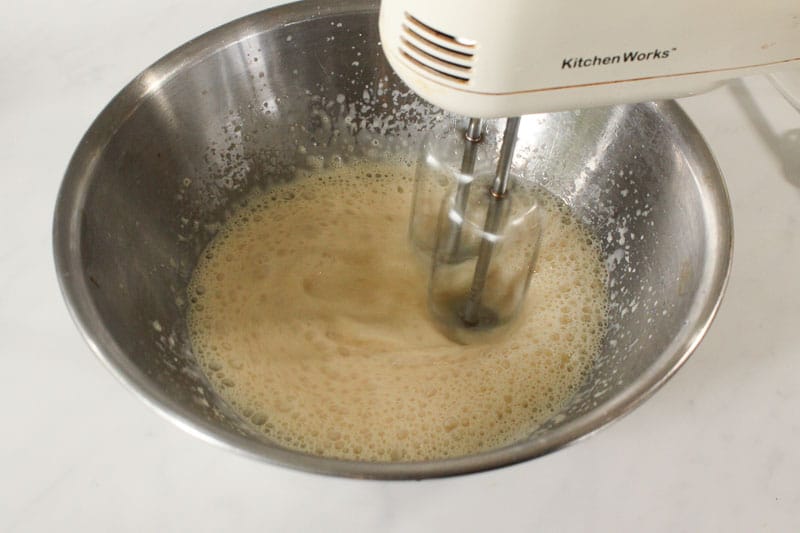Whipping Evaporated Milk with Mixer in Metal Bowl.