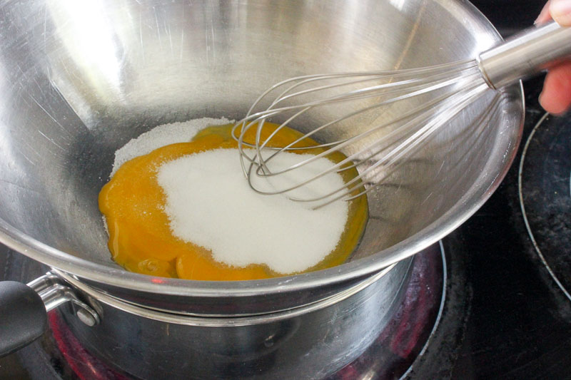 Whisking Sugar into Egg Yolks on Double Boiler.