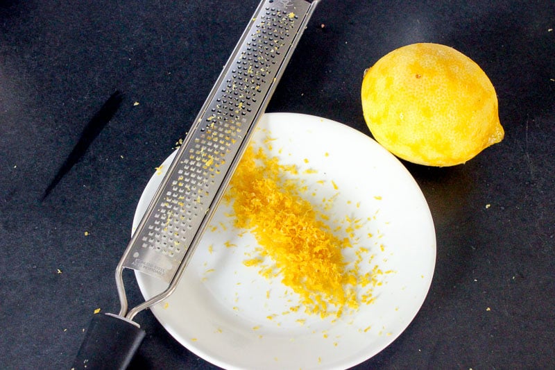 Lemon Zest and Microplane on White Plate.