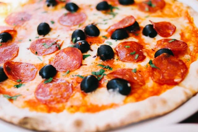 Close up of pepperoni pizza with black olives