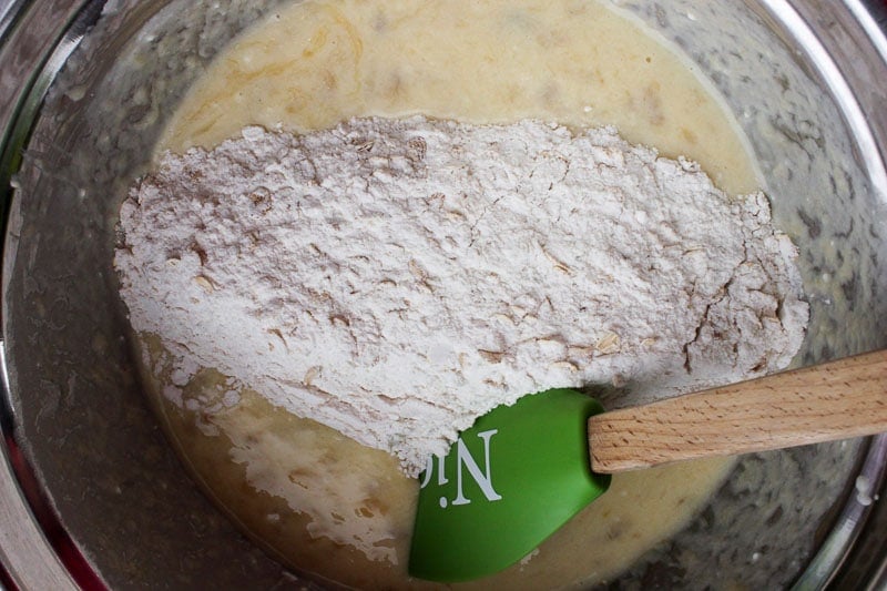 Adding Dry Ingredients to Donut Batter in Metal Mixing Bowl.