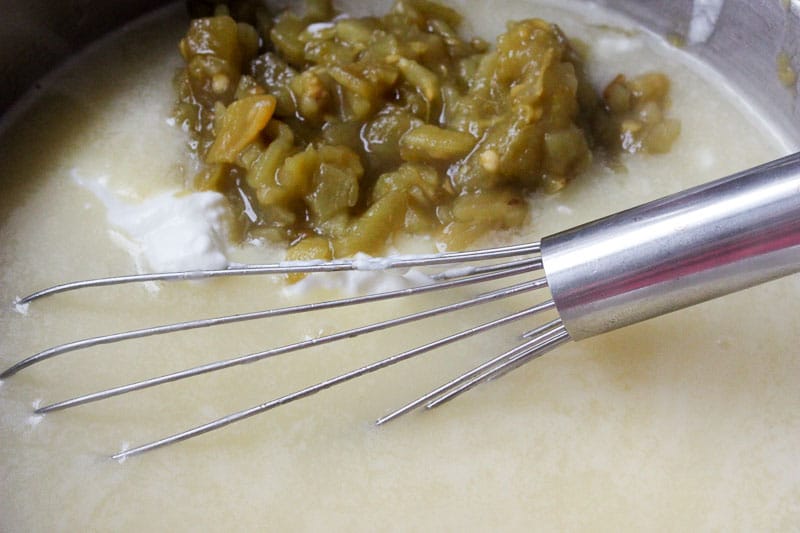 Adding Yogurt and Chillies to White Sauce.