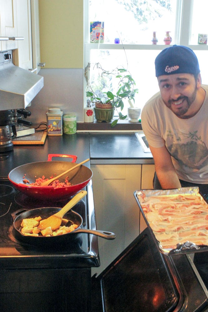 Man putting raw bacon in Oven.